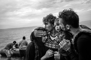 A Syrian family weeps tears of joy after reaching, on a rubber boat from Turkey, the village of Skala Sykaminias located on the northeastern Greek island of Lesbos, on October 10, 2015.  Thousand of refugees, mostly coming from Syria, Iraq and Afghanistan, cross everyday the Aegean sea from Turkey to reach Europe: a relatively short but extremely perilous journey. According to the UN Refugee Agency, more than 850 000 arrivals by sea were registered in Greece in 2015.
